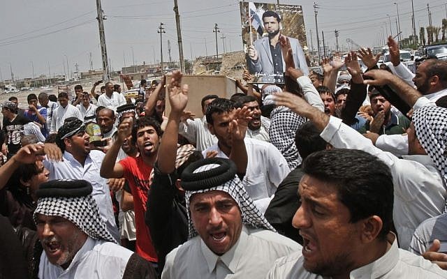 Family members of Diaa Mutashar al-Issawi, seen in the poster, chant anti-Jabhat al-Nusra and Free Syrian Army slogans during his funeral in Basra on Monday. (photo credit: AP/ Nabil Al-Jurani) Family members of Diaa Mutashar al-Issawi, seen in the poster, chant anti-Jabhat al-Nusra and Free Syrian Army slogans during his funeral in Basra on Monday. (photo credit: AP/ Nabil Al-Jurani)