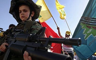 A Lebanese boy at a Hezbollah rally in Lebanon in May.  (photo credit: AP/Hussein Malla)
