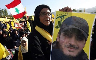 A Hezbollah supporter holds a portrait of her son, Ibrahim Kanso, 24, who was killed 40 days before, at Sayida Zeinab shrine during a battle in Syria against the Syrian rebels, May 24 (AP Photo/Hussein Malla)