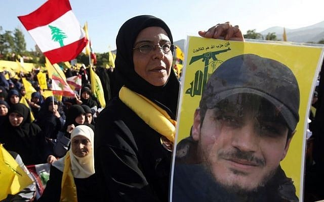 A Hezbollah supporter holds a portrait of her son, Ibrahim Kanso, 24, who was killed 40 days before, at Sayida Zeinab shrine during a battle in Syria against the Syrian rebels, May 24 (AP Photo/Hussein Malla) A Hezbollah supporter holds a portrait of her son, Ibrahim Kanso, 24, who was killed 40 days before, at Sayida Zeinab shrine during a battle in Syria against the Syrian rebels, May 24 (AP Photo/Hussein Malla)