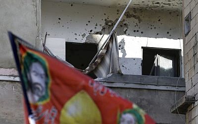 A house in Beirut hit by rockets Sunday (photo credit: Hussein Malla/AP)
