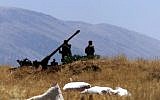 Illustrative photo of Syrian soldiers preparing an anti-aircraft gun, 2001. (photo credit: AP/File)