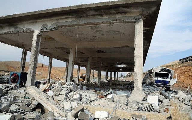 Damaged buildings wrecked by an Israeli airstrike, in Damascus, Syria, on Sunday, May 5, 2013. (photo credit: AP Photo/SANA) Damaged buildings wrecked by an Israeli airstrike, in Damascus, Syria, on Sunday, May 5, 2013. (photo credit: AP Photo/SANA)