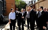 Syrian President Bashar Assad, center, visits the Umayyad Electrical Station on May Day, May 1, 2013, a day after a powerful bomb hit the capital (photo credit: AP/SANA)