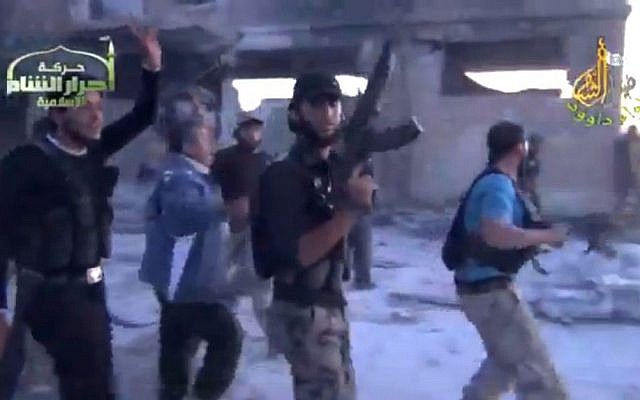 In this image from amateur video obtained by a group which calls itself Ugarit News, rebel fighters celebrate after purportedly capturing an army base in Nairab, northwestern Syria, on Thursday, MAy 25. (photo credit: AP Photo/Ugarit News via AP video) In this image from amateur video obtained by a group which calls itself Ugarit News, rebel fighters celebrate after purportedly capturing an army base in Nairab, northwestern Syria, on Thursday, MAy 25. (photo credit: AP Photo/Ugarit News via AP video)