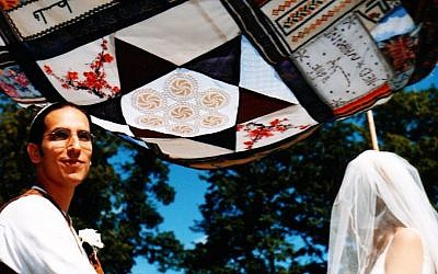 Ned Lazarus and Nahanni Rous standing under the chuppah made from the fabric sheets brought by their guests, 2004. (photo credit: Courtesy Nahanni Rous/JTA)