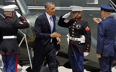 Air Force Col. Bill Knight, right, greets Barack Obama at Andrews Air Force Base on Monday before Obama boarded Air Force One to New York City for private fundraisers. (photo credit: AP/Ann Heisenfelt)