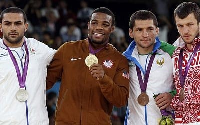 Silver medalist Sadegh Saeed Goudarzi, from Iran; gold medalist Jordan Ernest Burroughs, from the US; bronze medalist Soslan Tigiev, from Uzbekistan; and bronze medalist Denis Tsargush, from Russia, participate in the medals ceremony for men's 74-kg freestyle wrestling competition at the 2012 Summer Olympics, in London, Friday, August 10, 2012. (photo credit: AP/Paul Sancya, File)