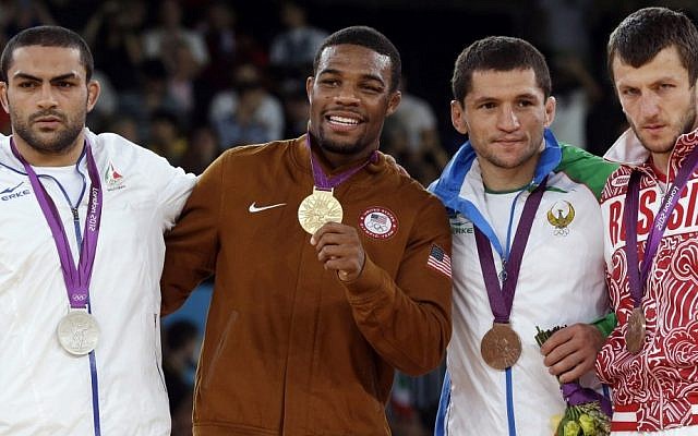 Silver medalist Sadegh Saeed Goudarzi, from Iran; gold medalist Jordan Ernest Burroughs, from the US; bronze medalist Soslan Tigiev, from Uzbekistan; and bronze medalist Denis Tsargush, from Russia, participate in the medals ceremony for men's 74-kg freestyle wrestling competition at the 2012 Summer Olympics, in London, Friday, August 10, 2012. (photo credit: AP/Paul Sancya, File) Silver medalist Sadegh Saeed Goudarzi, from Iran; gold medalist Jordan Ernest Burroughs, from the US; bronze medalist Soslan Tigiev, from Uzbekistan; and bronze medalist Denis Tsargush, from Russia, participate in the medals ceremony for men's 74-kg freestyle wrestling competition at the 2012 Summer Olympics, in London, Friday, August 10, 2012. (photo credit: AP/Paul Sancya, File)