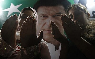 Supporters of Pakistan's cricket star-turned-politician Imran Khan pray for their leader's health in Karachi, Pakistan on Tuesday, May 7, 2013. One of Pakistan’s most prominent politicians, Khan fell from a stage at a political rally Tuesday in Lahore, leaving him with two hairline skull fractures and uncertainty hanging over his ability to campaign ahead of Saturday’s general election. (AP Photo/Shakil Adil)