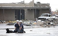 Searchers rest from operations after the tornado in Moore, Oaklahoma, on, Monday, May 20, 2013. (photo credit: AP Photo/The Oklahoman, David McDaniel)