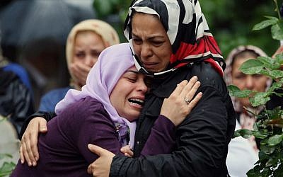 Mourning relatives during the burial of one of the 46 victims killed in Saturday explosions in Reyhanli, near Turkey's border with Syria, Sunday, May 12, 2013. (photo credit: AP/Burhan Ozbilici)
