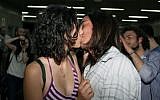 A young Turkish couple kiss to protest subway official's harassment of a couple for kissing in public last week, inside a subway stop in Ankara, Turkey, Saturday, May 25 (photo credit: AP/Burhan Ozbilici)