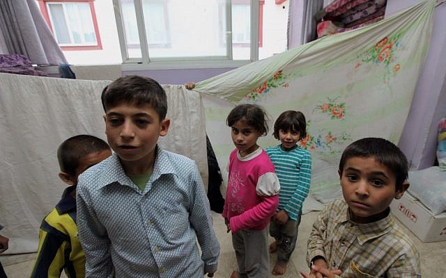 Syrian refugees shelter in a two-story wedding ceremony hall in the Turkish town of Reyhanli, near the border with Syria, Sunday, May 12, 2013, (photo credit: AP/Burhan Ozbilici) Syrian refugees shelter in a two-story wedding ceremony hall in the Turkish town of Reyhanli, near the border with Syria, Sunday, May 12, 2013, (photo credit: AP/Burhan Ozbilici)