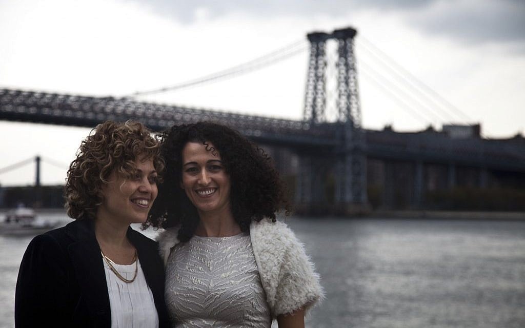 Tzila Levy, left, and Adi Lavy, married on New York City's Williamsburg Bridge, seen in the background, Oct. 27, 2012. (photo credit: Courtesy Immigration Equality/JTA) Tzila Levy, left, and Adi Lavy, married on New York City's Williamsburg Bridge, seen in the background, Oct. 27, 2012. (photo credit: Courtesy Immigration Equality/JTA)