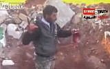 A frame from a video apparently showing a Syrian rebel biting into the heart of a slain regime soldier (photo credit: screenshot YouTube)
