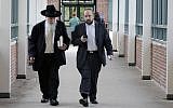 Yosef Kolko, right, walks with an unidentified man, near the Ocean County Courthouse in Toms River, NJ, Thursday, May 9, 2013, during a break in his trial on sexual assault charges. (photo credit: AP Photo/Mel Evans)