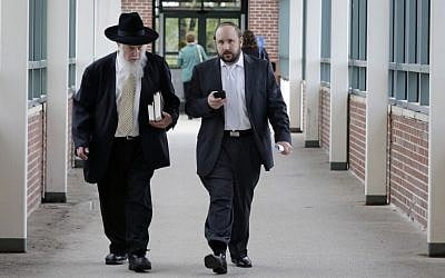 Yosef Kolko, right, walks with an unidentified man, near the Ocean County Courthouse in Toms River, NJ, Thursday, May 9, 2013, during a break in his trial on sexual assault charges. (photo credit: AP Photo/Mel Evans)