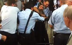 Coptic priest Father Arsanios struggles with several Israeli policemen in Jerusalem's Old City, on May 4, 2013. (photo credit: YouTube/Maariv)