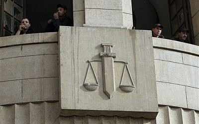 Egyptian policemen stand alert at the general prosecutor's office during a protest in Cairo, Thursday, May 9 2013 (photo credit: AP Photo/Amr Nabil)