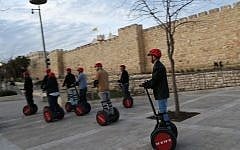 Tourists ride Segways near the walls of Jerusalem's Old City, March 7, 2013. (photo credit: Nati Shohat/Flash90)