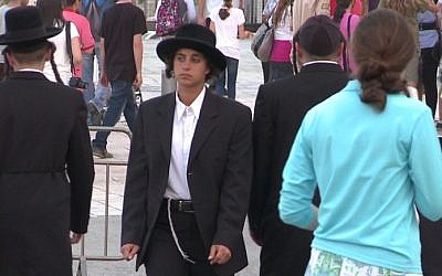 Filmmaker Jessie Kahnweiler tries a Hasidic man's suit on for size in her new web series, 'Dude, Where's My Chutzpah?' (photo credit: courtesy of Jessie Kahnweiler)
