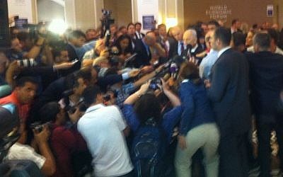 Shimon Peres surrounded by journalists at the World Economic Forum in Jordan on Sunday (photo credit: Times of Israel staff)