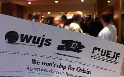 'We won't clap for Orban' leaflets, the WJC, Sunday (photo credit: Aaron Kalman/TimesofIsrael)