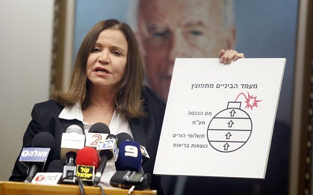 Labor Party leader, Shelly Yachimovich, at a press conference, May 5, 2013, appropriating Benjamin Netanyahu's nuclear bomb to highlight the financial plight of Israel's middle classes (photo credit: Flash90) Labor Party leader, Shelly Yachimovich, at a press conference, May 5, 2013, appropriating Benjamin Netanyahu's nuclear bomb to highlight the financial plight of Israel's middle classes (photo credit: Flash90)
