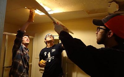 Students from Rutgers University Hillel and Hillel at the University of Illinois at Urbana-Champaign work on repairs in a home that was badly damaged during the Joplin tornado (Courtesy of JDRC)