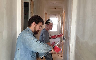 Jacob Holzer (University of Rhode Island) and Blake Stein (Towson University) hard at work at Roger’s house.  Roger lost a brother during the tornado. (Courtesy of JDRC)