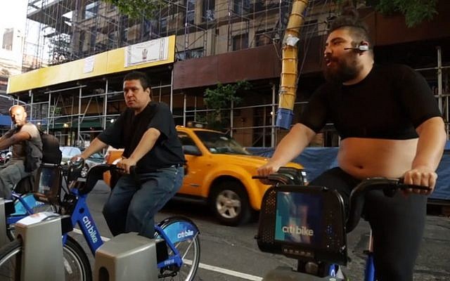 The Fat Jew (aka Fabrizio Goldstein), right leads a spinning class for New Yorkers on docked Citi Bikes. (photo credit: YouTube screenshot) The Fat Jew (aka Fabrizio Goldstein), right leads a spinning class for New Yorkers on docked Citi Bikes. (photo credit: YouTube screenshot)