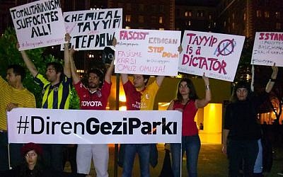 Turkish protesters hold up signs rebuking Prime Minister Recep Tayyip Erdogan's government and calling for support for Gezi Park at a protest in Istanbul. (photo credit: Facebook)