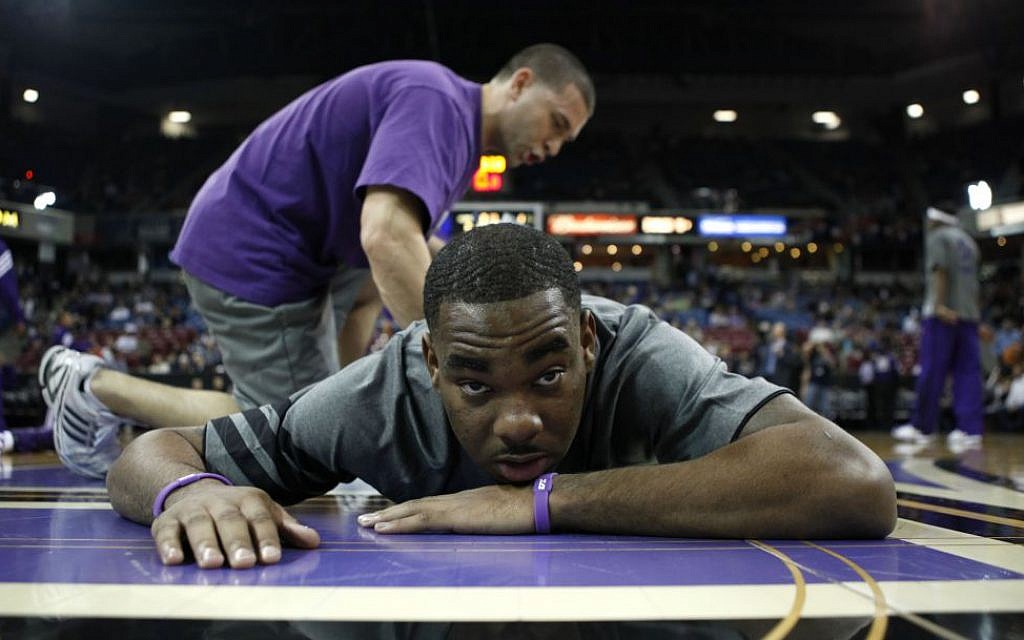 Sacramento Kings guard Marcus Thornton is seen getting stretched out from Kings strength and conditioning coach Daniel Shapiro before their NBA basketball game against the Orlando Magic in Sacramento, Calif, Jan. 8, 2012. (photo credit: AP Photo/Rich Pedroncelli) Sacramento Kings guard Marcus Thornton is seen getting stretched out from Kings strength and conditioning coach Daniel Shapiro before their NBA basketball game against the Orlando Magic in Sacramento, Calif, Jan. 8, 2012. (photo credit: AP Photo/Rich Pedroncelli)