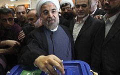 Iranian presidential candidate Hasan Rowhani, a former top nuclear negotiator, casts his ballot during presidential elections at a polling station in downtown Tehran on Friday (photo credit: AP/Vahid Salemi)
