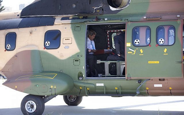 US Secretary of State John Kerry waits for departure after boarding a Jordanian helicopter in Jerusalem, en route to Amman, Jordan, to meet with Palestinian President Mahmoud Abbas, Saturday, June 29, 2013. (photo credit: AP /Jacquelyn Martin)