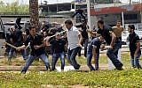 Hezbollah supporters clash with supporters of the Lebanese Option Party during a protest in front of the Iranian Embassy in Beirut, Lebanon, Sunday, June 9, 2013 (photo credit: AP)