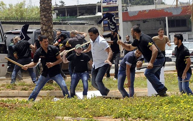 Hezbollah supporters clash with supporters of the Lebanese Option Party during a protest in front of the Iranian Embassy in Beirut, Lebanon, Sunday, June 9, 2013 (photo credit: AP) Hezbollah supporters clash with supporters of the Lebanese Option Party during a protest in front of the Iranian Embassy in Beirut, Lebanon, Sunday, June 9, 2013 (photo credit: AP)
