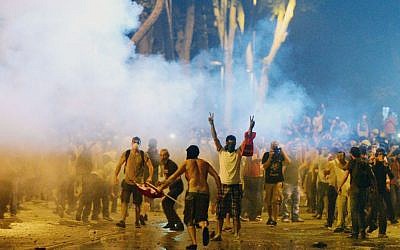 Turkish protesters clash with riot police near the former Ottoman palace, Dolmabahce, where Turkey's Prime Minister Recep Tayyip Erdogan maintains an office in Istanbul, Turkey, on June 1, 2013. (photo credit: AP)