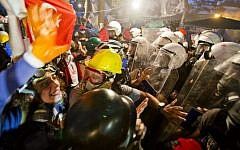Protesters try to resist the advance of riot police in Gezi park in Istanbul, Turkey, Saturday, June 15, 2013. (Photo credit: AP/Vadim Ghirda)