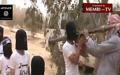 Children stand in line to receive weapons at the Al-Qaeda training camp at Bukamal (photo credit: video grab/MEMRI TV)