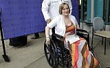 Boston Marathon bombing survivor Erika Brannock, 29, a Baltimore area pre-school teacher who lost a leg, wheels away from a news conference as she is released from Beth Israel Deaconess Medical Center in Boston, Monday, June 3, 2013. (photo credit: AP Photo/Elise Amendola)