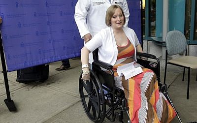 Boston Marathon bombing survivor Erika Brannock, 29, a Baltimore area pre-school teacher who lost a leg, wheels away from a news conference as she is released from Beth Israel Deaconess Medical Center in Boston, Monday, June 3, 2013. (photo credit: AP Photo/Elise Amendola)