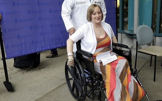Boston Marathon bombing survivor Erika Brannock, 29, a Baltimore area pre-school teacher who lost a leg, wheels away from a news conference as she is released from Beth Israel Deaconess Medical Center in Boston, Monday, June 3, 2013. (photo credit: AP Photo/Elise Amendola) Boston Marathon bombing survivor Erika Brannock, 29, a Baltimore area pre-school teacher who lost a leg, wheels away from a news conference as she is released from Beth Israel Deaconess Medical Center in Boston, Monday, June 3, 2013. (photo credit: AP Photo/Elise Amendola)