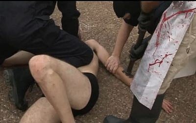 An Israeli animal rights activist is banded in Tel Aviv in solidarity with cattle. (screen capture: Youtube/269lifecom)