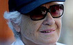An elderly woman wears a cap reading 'Grandmother' (Illustrative photo credit: Moshe Shai/FLASH90)