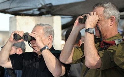Prime Minister Benjamin Netanyahu, left, and then-IDF chief of staff Lt. Gen. Benny Gantz watch a military exercise of the army's Golani Brigade on the Golan Heights, September 11, 2012. (Avi Ohayon/GPO/Flash90)