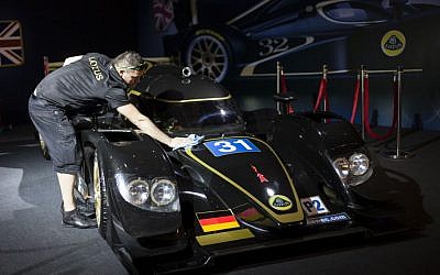 A Lotus technical crew member prepares a British Lotus LMP2 for display, prior to the opening of a racing car and motorcycle exhibition held at the Old Jerusalem Train Station (photo credit: Flash 90)