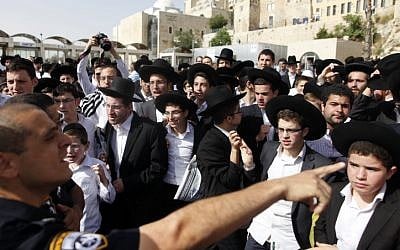 Ultra-Orthodox men protest against the Women of the Wall's start of the month prayer gathering at the Western Wall on Sunday, June 9 (photo credit: FLash90)