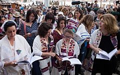 Women of the Wall members wearing prayer shawls pray at the Western Wall (photo credit: Sarah Schuman/Flash90)